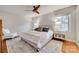 Comfortable main bedroom with hardwood floors, natural light, and a calming color palette at 6626 Rocky Falls Rd, Charlotte, NC 28211