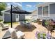 Outdoor patio area featuring modern furniture, an umbrella, and string lights perfect for entertaining at 7043 Blakeney Greens Blvd, Charlotte, NC 28277