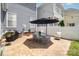 Backyard patio with outdoor dining set, grill, and a white fence providing a private outdoor space at 7043 Blakeney Greens Blvd, Charlotte, NC 28277