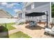 Spacious backyard patio with modern outdoor seating, string lights, and access to a well-maintained lawn at 7043 Blakeney Greens Blvd, Charlotte, NC 28277