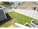 Fenced backyard with partially mowed lawn, mulch, and exterior A/C units; good for outdoor enjoyment at 7043 Blakeney Greens Blvd, Charlotte, NC 28277