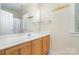Neutral bathroom with a large mirror and wooden vanity at 7043 Blakeney Greens Blvd, Charlotte, NC 28277