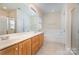 Bright bathroom with double vanity, soaking tub, and glass-enclosed shower at 7043 Blakeney Greens Blvd, Charlotte, NC 28277