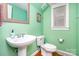 Charming mint green bathroom with pedestal sink and framed mirror at 7043 Blakeney Greens Blvd, Charlotte, NC 28277