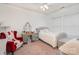 Bright bedroom with red chair, vintage vanity and a comfy bed at 7043 Blakeney Greens Blvd, Charlotte, NC 28277