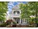Charming two-story home with a covered front porch and manicured landscaping at 7043 Blakeney Greens Blvd, Charlotte, NC 28277