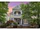 Charming two-story home with a front porch and landscaped yard during dusk at 7043 Blakeney Greens Blvd, Charlotte, NC 28277