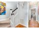 Staircase features art, carpeted treads, and an opening to another room at 7043 Blakeney Greens Blvd, Charlotte, NC 28277