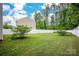 Green backyard with a well-maintained lawn and privacy fence, great for outdoor activities at 7527 Finnigan Rd, Charlotte, NC 28215