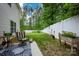 Well-maintained backyard with a patio, green lawn, and privacy fence, perfect for outdoor enjoyment at 7527 Finnigan Rd, Charlotte, NC 28215