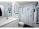 Charming bathroom featuring blue accent wall and white shower curtain with floral pattern at 7527 Finnigan Rd, Charlotte, NC 28215