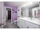 Stylish bathroom featuring a double vanity, modern fixtures, and eye-catching purple accent wall at 7527 Finnigan Rd, Charlotte, NC 28215