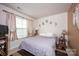 Cozy bedroom with neutral tones, soft lighting, and a comfortable bed, creating a relaxing atmosphere at 7527 Finnigan Rd, Charlotte, NC 28215