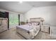 Bright bedroom featuring a queen-sized bed with a patterned duvet and coordinating decor at 7527 Finnigan Rd, Charlotte, NC 28215