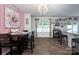 Bright dining area with ample seating, a modern chandelier, and a view of the backyard at 7527 Finnigan Rd, Charlotte, NC 28215
