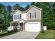 Charming two-story home with a manicured lawn and a two-car garage in a quiet neighborhood at 7527 Finnigan Rd, Charlotte, NC 28215