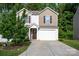Charming two-story home with a well-manicured lawn and a two car garage at 7527 Finnigan Rd, Charlotte, NC 28215