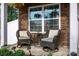 Cozy front porch with comfortable wicker seating, perfect for relaxing outdoors at 7527 Finnigan Rd, Charlotte, NC 28215