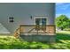 A sliding glass door opens to a wooden deck and lush yard at 7874 Lucky Creek Ln, Denver, NC 28037