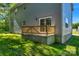 Back deck features a wooden railing and sliding glass door, offering easy access to the backyard and home at 7874 Lucky Creek Ln, Denver, NC 28037