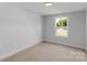 Neutral bedroom featuring a large window for plenty of natural light at 7874 Lucky Creek Ln, Denver, NC 28037