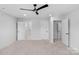 Neutral bedroom featuring multiple doors for easy access and a modern ceiling fan at 7874 Lucky Creek Ln, Denver, NC 28037