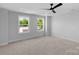 Neutral bedroom featuring large windows for plenty of natural light and a ceiling fan at 7874 Lucky Creek Ln, Denver, NC 28037