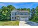 Charming two-story home with a light blue exterior, attached two-car garage, and well-maintained lawn at 7874 Lucky Creek Ln, Denver, NC 28037