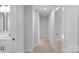 Bright hallway featuring neutral tones, carpet flooring, and modern lighting for a clean, minimalist aesthetic at 7874 Lucky Creek Ln, Denver, NC 28037