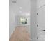 Bright hallway leads to an open-concept living area with natural light and modern finishes at 7874 Lucky Creek Ln, Denver, NC 28037