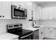 Close-up of a modern kitchen with stainless steel appliances and white subway tile backsplash at 7874 Lucky Creek Ln, Denver, NC 28037