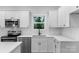 Well-lit kitchen featuring stainless steel appliances, white cabinets and subway tile backsplash at 7874 Lucky Creek Ln, Denver, NC 28037