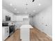 Bright kitchen featuring white cabinets, stainless steel appliances, and a large center island at 7874 Lucky Creek Ln, Denver, NC 28037