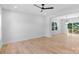 Spacious living room with hardwood floors, white walls, ceiling fan and sliding glass doors to the deck at 7874 Lucky Creek Ln, Denver, NC 28037