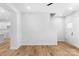 Bright and airy living room with hardwood floors and white walls offering seamless flow and modern design at 7874 Lucky Creek Ln, Denver, NC 28037