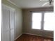 Cozy bedroom featuring hardwood floors, natural light, closet and neutral walls at 809 Ruth Ave, Kannapolis, NC 28083