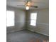 Bedroom with plush carpet, fresh neutral paint, a ceiling fan, and bright, sunny windows at 809 Ruth Ave, Kannapolis, NC 28083