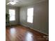 Bright bedroom featuring hardwood floors, neutral walls, and two sunny windows at 809 Ruth Ave, Kannapolis, NC 28083