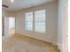 The spacious bedroom has plush carpet, two windows, and ample natural light at 8102 Jacey Ln # 24, Huntersville, NC 28078