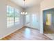 Dining area features modern chandelier, french doors, and light hardwood flooring at 8102 Jacey Ln # 24, Huntersville, NC 28078
