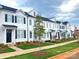 Exterior view of newly-built townhomes with manicured lawns and fresh landscaping under a cloudy sky at 8102 Jacey Ln # 24, Huntersville, NC 28078