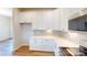 Modern kitchen with white cabinets, stainless appliances, and stylish backsplash at 8102 Jacey Ln # 24, Huntersville, NC 28078