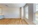 Living room boasts hardwood floors, white walls, and plenty of natural light from large windows at 8102 Jacey Ln # 24, Huntersville, NC 28078