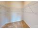 Walk-in closet offers ample storage with wire shelving and neutral carpeting at 8102 Jacey Ln # 24, Huntersville, NC 28078