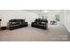 Finished basement with a theater setup including black leather chairs and a drum set at 8217 Lansford Rd, Charlotte, NC 28277