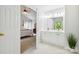 Open view of the bath, showing the entrance from the bedroom and white vanity at 8217 Lansford Rd, Charlotte, NC 28277