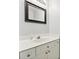 This bathroom features a well-lit vanity with white cabinets and a framed mirror, perfect for a quick refresh at 8217 Lansford Rd, Charlotte, NC 28277