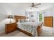 Cozy bedroom featuring a ceiling fan, wood furnishings, and a light blue floral comforter at 8217 Lansford Rd, Charlotte, NC 28277