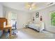 Neutral-toned bedroom featuring light carpet, a desk area, and a twin bed at 8217 Lansford Rd, Charlotte, NC 28277
