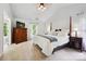 Light-filled main bedroom featuring vaulted ceiling and elegant four-poster bed at 8217 Lansford Rd, Charlotte, NC 28277